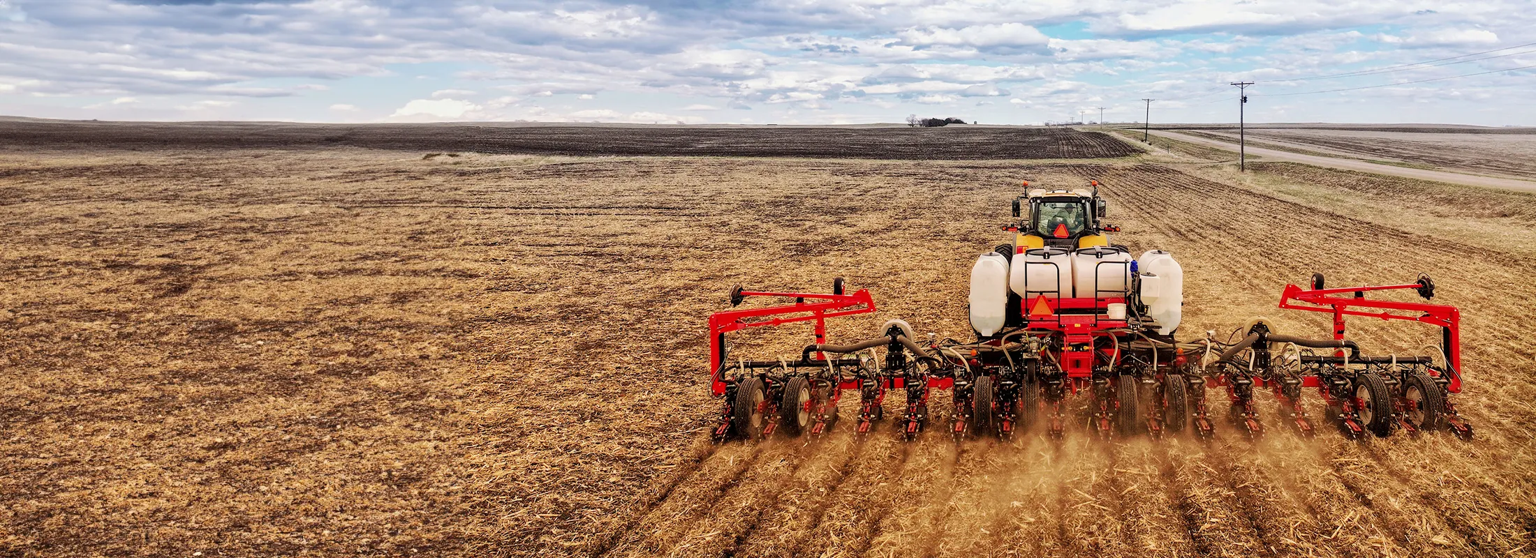 a tractor pulling a tillage across a field