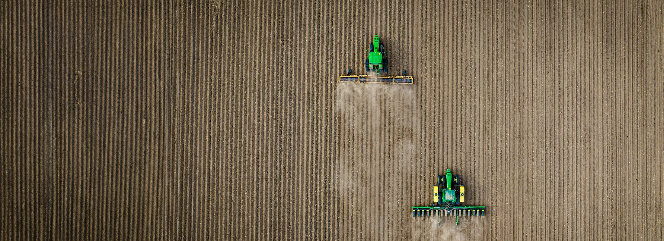 two tractors working a field